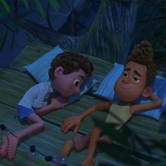 two children laying on a bed in the jungle