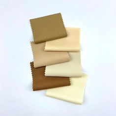 several different shades of fabric sitting on top of each other, one brown and one white