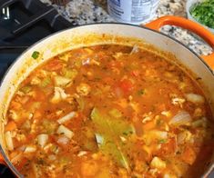 a pot filled with soup sitting on top of a stove