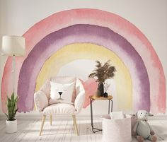 a living room with a rainbow painted on the wall next to a chair and potted plant