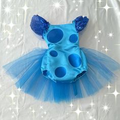 a blue bodysuit with polka dots on the front, and a blue tutu skirt