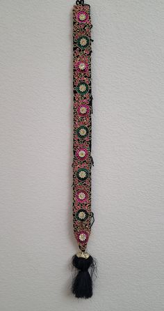 Premium handmade Aari work Jada Billa for Girls/Women *Handmade Full Aari Work in the jada. *Kunjalam at the bottom for hair decoration. *Ornaments attached along the hair braid. *Handmade item with small beads and stones. *Colorful and Flower climber designs with kundan stones. *Total length of Jada Billas is 32 inches. *Has hooks on the top and black threads to attach with the hair. For occasions like wedding, baby shower party, party, bridesmaids, engagement, anniversary, or other special occ Traditional Kundan Wear With Handwork, Traditional Choli With Dori Work For Puja, Traditional Wear With Handwork For Navratri Puja, Traditional Silk Thread Choli With Multicolor Embroidery, Ceremonial Handwork Dupatta For Eid, Traditional Silk Choli With Multicolor Embroidery, Traditional Multicolor Embroidered Silk Choli, Traditional Saree With Mirror Work, Traditional Multicolor Choli For Ceremonial Use