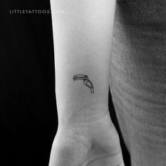 a black and white photo of a person's arm with a tattoo on it