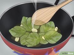 a pan filled with green vegetables cooking on top of a stove