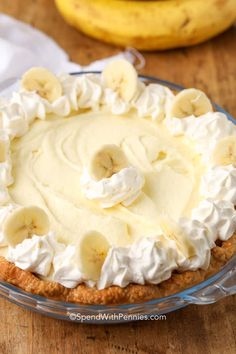 a banana cream pie sitting on top of a wooden table