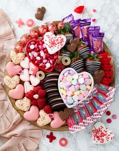 valentine's day dessert platter with heart shaped candies, chocolates and marshmallows