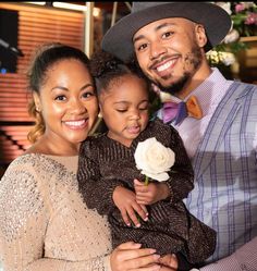 a man, woman and child are smiling for the camera