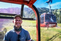 a man standing in front of a cable car