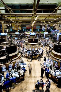 an overhead view of a stock market with lots of monitors and people working on their computers