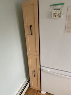 a white refrigerator freezer sitting in a kitchen next to a wooden floor and wall