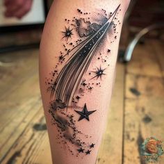 a black and white tattoo with stars in the sky on someone's leg,