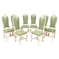 a set of eight chairs with green upholstered seats