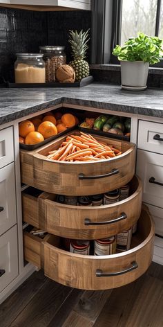 an open drawer in the corner of a kitchen with fruit and vegetables on it's sides