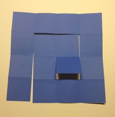 a piece of blue paper with a square in the middle and a rectangle on top