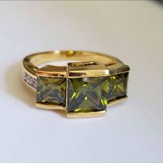 New 18k Gold Plated Princess Cut Peridot Ring For Women All Gemstones Are Simulated. A Jewelry Box Included. Ready To Ship Same Day. Feel Free To Ask Any Question. All Photos Are Real Time From Actual Object No Stock Photo Used. Color Might Be Slightly Different Due To Lighting. Elegant Peridot Emerald Promise Ring, Green Cubic Zirconia Ring For Formal Occasions, Green Cubic Zirconia Formal Ring, Formal Green Cubic Zirconia Ring, Gold Emerald Ring With Vs Clarity For Anniversary, Luxury Gold Jewelry With Peridot, Luxury Gold Peridot Jewelry, Elegant Gold Multi-stone Emerald Ring, Elegant Multi-stone Emerald Ring In Gold