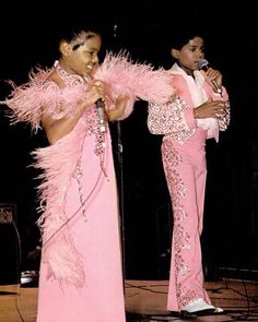 two women in pink outfits on stage with microphone and music stand behind them, the title'the littlest jackson '