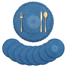 blue placemats with gold forks and spoons on them, set against a white background