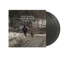 a black vinyl album with an image of a man running down a road in the snow