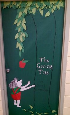 a door decorated with the giving tree and an apple