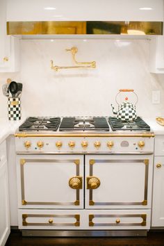 a white stove top oven sitting inside of a kitchen next to a wall mounted oven