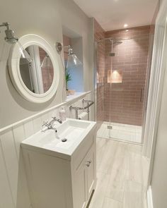 a white sink sitting next to a walk in shower