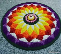 a colorful flower design on the ground next to a candy bar