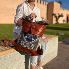 Elevate your style with our Big Leather Backpack, meticulously crafted using traditional Marrakech techniques. The Roll Top design showcases the artistry of leather tanning with oil and salt treatment, resulting in a backpack that not only looks great but is incredibly durable. This leather rucksack exudes a vintage charm that deepens over time, offering a rich and natural aesthetic that complements any outfit. The unique combination of leather and embroidered carpet fabric sets this backpack ap Leather Roll Top Backpack, Boho Backpacks, Bohemian Backpack, Marrakech Style, Leather Tanning, Hippie Backpack, Roll Top Backpack, Boho Backpack, Carpet Fabric