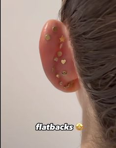 a close up of a person's ear with gold confetti on it