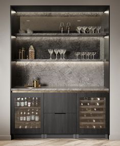 an empty bar with wine glasses and bottles on the shelves, in front of a gray wall