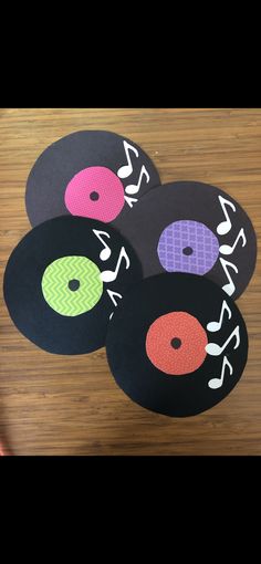 four black and white records with colorful circles on them