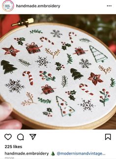 someone is holding up a cross stitch christmas ornament