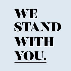 the words we stand with you are in black on a light blue background, and there is