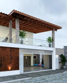 a modern house with wood and glass on the roof, surrounded by cobblestones