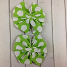 two green and white polka dot hair bows