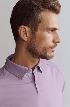 Stretchy, moisture-wicking fabric keeps you as comfortable as you look in a travel-ready polo that resists both wrinkles and odors to help you stay fresh. 27 1/2" length (size Medium) Hidden-button collar Short sleeves Moisture-wicking fabric engineered for dryness and comfort GoldFusion antimicrobial fabric engineered to inhibit the growth of odor-causing germs 86% recycled polyamide, 14% elastane Machine wash, tumble dry Imported Stretch Polo Shirt For Work, Casual Collared Top, Casual Purple Business Tops, Casual Purple Tops For Business, Casual Collared Wrinkle-resistant Tops, Fitted Purple Collared Polo Shirt, Purple Fitted Collared Polo Shirt, Classic Fitted Purple Polo Shirt, Moisture-wicking Cotton Collared Polo Shirt