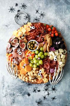 a platter filled with different types of halloween food and decorations on top of it