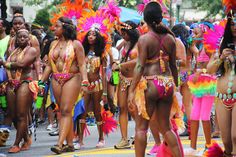 a group of women in colorful costumes walking down the street