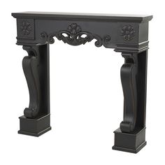 an ornate black fireplace mantel with carvings