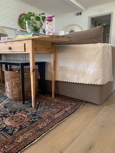 a living room with a couch, table and rug