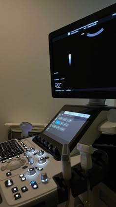 a computer monitor sitting on top of a desk next to a keyboard and mouse pad