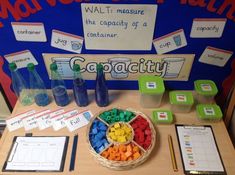 a table topped with lots of different types of legos next to cups and containers