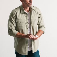 Description Details Care Fit Experience the ultimate comfort and style with the Guide Utility Shirt in light fatigue green stretch cotton poplin. Easily roll up your sleeves for a more casual look and pair it with your go-to denim and trusty hat. This shirt is perfect for all your adventures, city to safari. see more outfitting ideas here > • Soft casual spread collar • Masculine shoulder epaulettes• Well proportioned re-enforced chest pockets • Durable metal buttons• Comfortable 98% cotton 2% s Utility Long Sleeve Shirt With Patch Pockets, Unstructured Utility Shirt With Pockets, Unstructured Long Sleeve Utility Shirt, Khaki Relaxed Fit Utility Shirt, Cheap Utility Button-up Shirt, Shoulder Epaulettes, Banded Collar Shirts, Utility Shirt, Polo Pullover