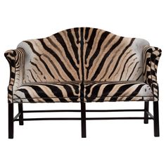 a zebra print chair with black legs