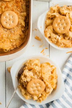 two bowls filled with baked macaroni and cheese on top of a white table