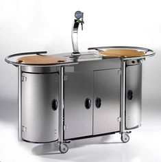 an image of a kitchen cart that is in the shape of a bar with wheels