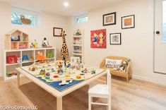 a child's playroom with toys and pictures on the wall