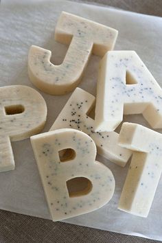 letters made out of cheese sitting on top of a piece of paper