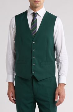 Bring understated elegance to the table in this three-piece suit crafted from rich fabric in a classic single-breasted silhouette. Jacket has notched lapels; chest welt pocket; front flap pockets Vest has front button closure; V-neck Pants have zip fly with button closure; front slant pockets; back button-welt pockets Jacket and vest are lined; trousers are lined to the knee 65% polyester, 35% viscose Dry clean Imported Each suit has a 6” drop, meaning that a size 38R jacket is paired with size Elegant Green Sets With Pockets, Professional Single Breasted Three-piece Suit For Semi-formal Occasions, Elegant Green Suits With Button Closure, Green Formal Suit With Pockets, Three-piece Suit With Button Closure For Work, Semi-formal Single Breasted Vest With Notch Lapel, Formal Vest With Notch Lapel And Button Closure, Semi-formal Single-breasted Vest With Notch Lapel, Tailored Vest With Hidden Button Closure And Notch Lapel