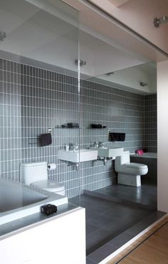 a bathroom with two sinks and mirrors in it