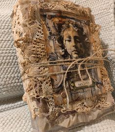 an altered photo is displayed on a piece of fabric and burlied linens